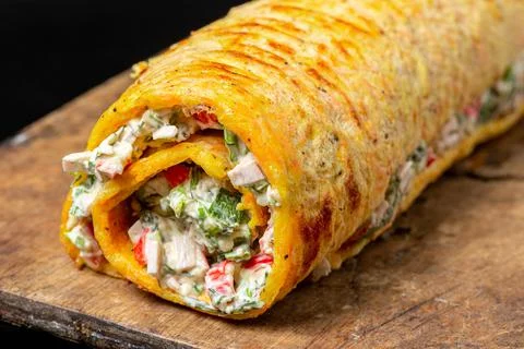 Egg roll with crab meat, herbs and cheese, close-up Stock Photos