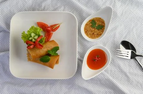 Egg roll or Fried Spring Rolls on the white plate Thai food. Top view. Stockfoto's