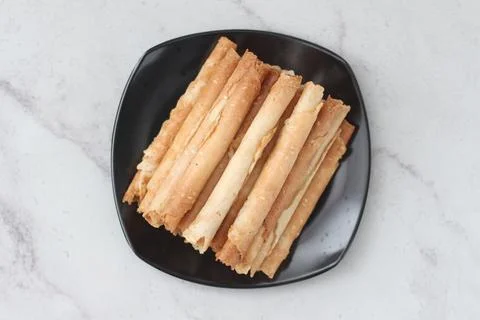 Egg roll or Semprong is snacks that normally serve on Hari Raya or Eid Al Fit Stock Photos