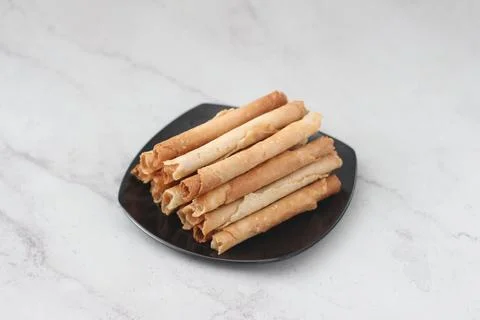 Egg roll or Semprong is snacks that normally serve on Hari Raya or Eid Al Fit Stock Photos