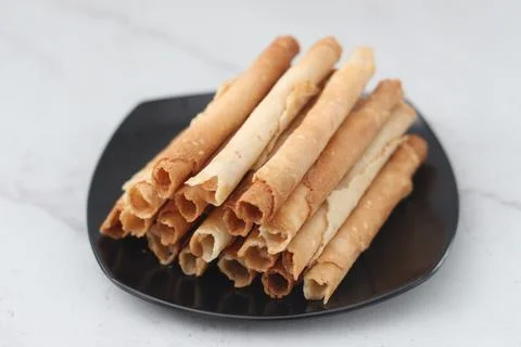 Egg roll or Semprong is snacks that normally serve on Hari Raya or Eid Al Fit Stock Photos