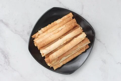 Egg roll or Semprong is snacks that normally serve on Hari Raya or Eid Al Fit Stock Photos