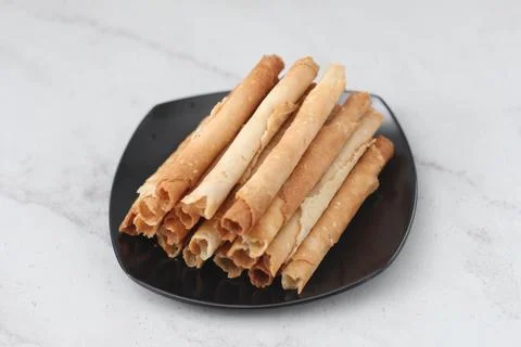 Egg roll or Semprong is snacks that normally serve on Hari Raya or Eid Al Fit Stock Photos
