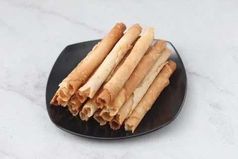 Egg roll or Semprong is snacks that normally serve on Hari Raya or Eid Al Fit Stock Photos