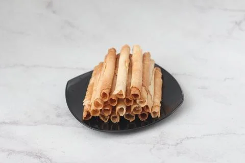 Egg roll or Semprong is snacks that normally serve on Hari Raya or Eid Al Fit Stock Photos