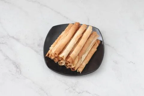 Egg roll or Semprong is snacks that normally serve on Hari Raya or Eid Al Fit Stock Photos