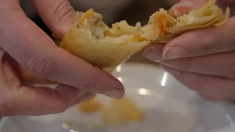 Egg roll torn in half slow motion oil comes out close up Stock Footage 229188460