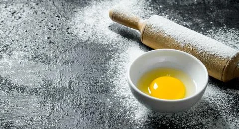 Egg with a rolling pin. Stock Photos