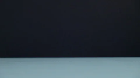 Egg rolling on the table on black background Stock Footage 124795037