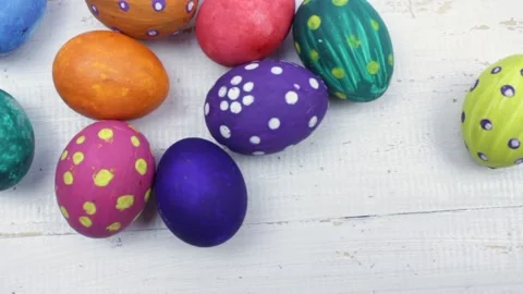 The egg is rolling on the white table. Easter eggs background. colorful eggs Stock Footage 147987743