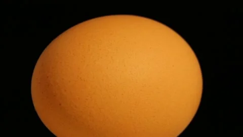 The egg rotates on a black background. Chicken egg is healthy and delicious food Stock Footage 167917292