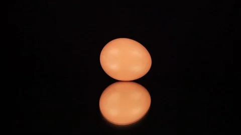 The egg rotates on a black background. Stock Footage