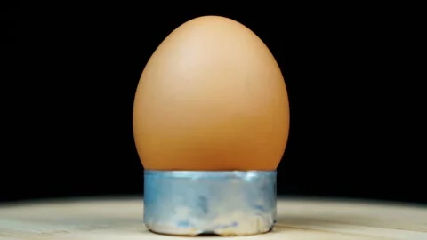 Egg rotating on isolated black Stock Footage 117438117