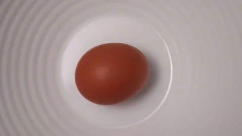 Egg rotation on a white background Stock Footage 129822253