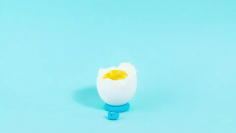 An egg with a sad expression is gradually eaten. Stock Footage 220230374