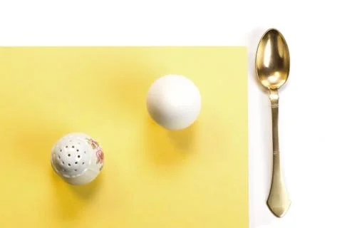 Egg, salt cellar and brass spoon Stock Photos