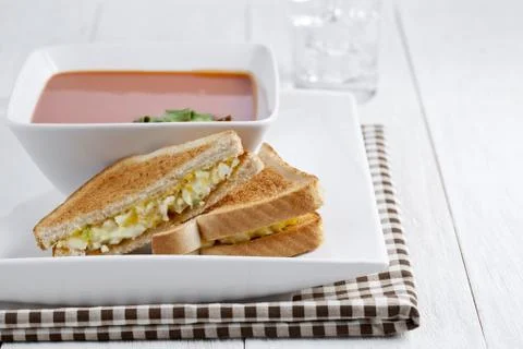 Egg sandwich and tomato soup bowl Stock Photos
