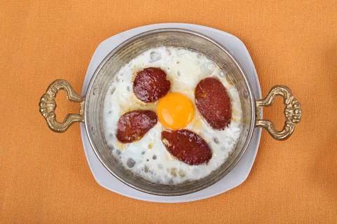 Egg sausage in a high-angle copper dish Stock Photos