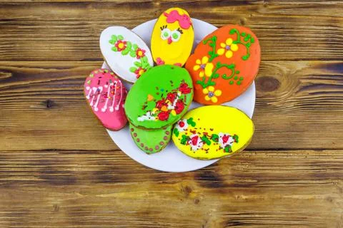 Egg shaped easter gingerbread cookies on wooden table. Top view. Stock Photos