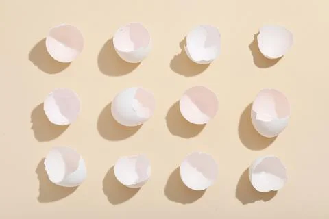 Egg shells on beige background Stock Photos