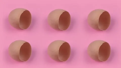 Egg shells on pink background Stock Footage 206819832