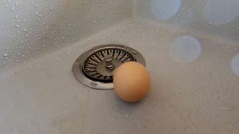 The egg slipped from his hand and broke. Stock Footage 128123399