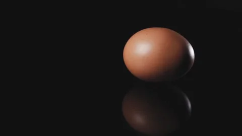 Egg spinning on a black background. Stock Footage 140247103