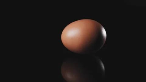 Egg spinning on a black background. Stock Footage 140247108