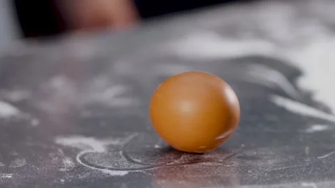Egg spinning. Chicken egg spinning on table background. Happy Easter. Video stock 156479204
