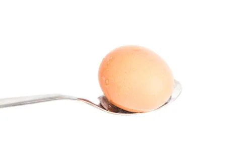 Egg on a spoon, isolated  white background Stockfoto's