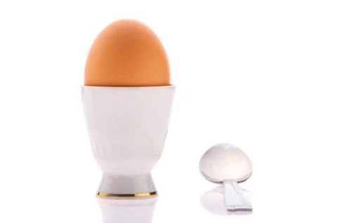 Egg on a stand with a spoon Foto stock