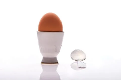 Egg on a stand with a spoon Foto stock