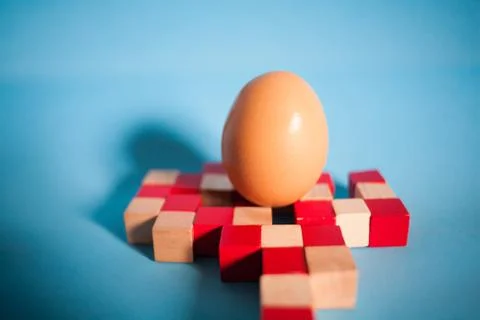 Egg standing on egg cup, isolated on white background Stock Photos