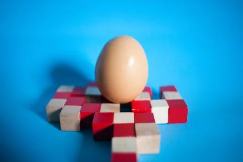 Egg standing on egg cup, isolated on white background Stock Photos