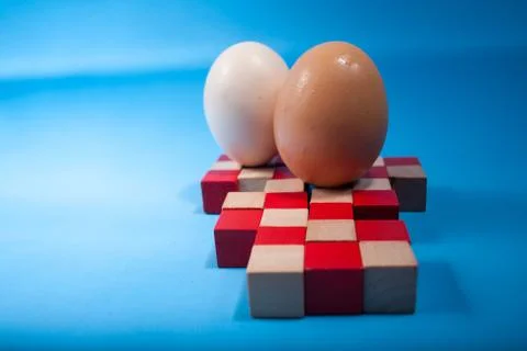 Egg standing on egg cup, isolated on white background Stock Photos