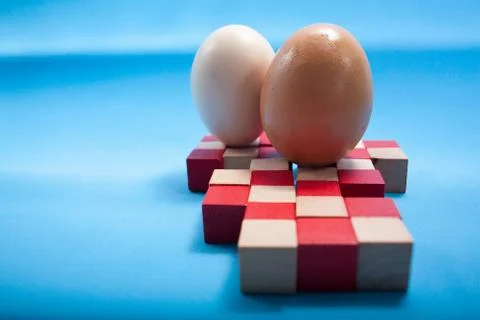 Egg standing on egg cup, isolated on white background Stock Photos