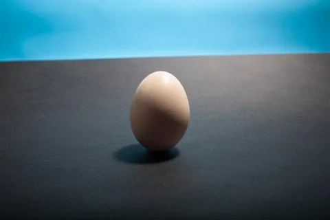 Egg standing on egg cup, isolated on white background Foto stock