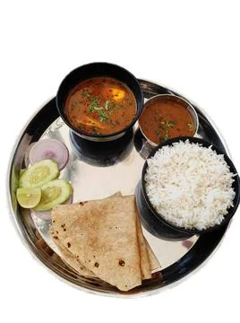 Egg thali served with 2 chapatis, egg curry, white rice, and salad in a steel Stock Photos