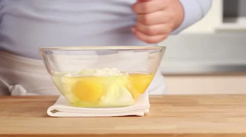 Egg topping being made: creme fraiche and eggs being seasoned and stirred Video stock 24670038