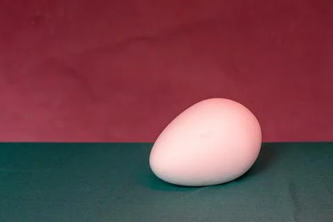 Egg on a uniform background of two colors Stock Photos