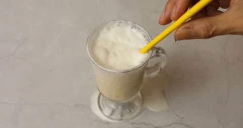 Egg vanilla milkshake in glass on table Stock Footage 114206523