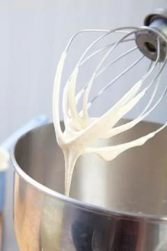 An egg whisk on a food processor with remnants of beaten egg white Stock Photos