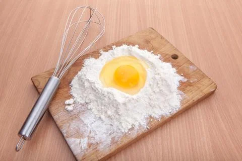 Egg white and yolk in floor on kitchen table Stock Photos