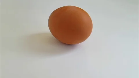 Egg on a white background spinning, slow-motion Stock Footage 88000905