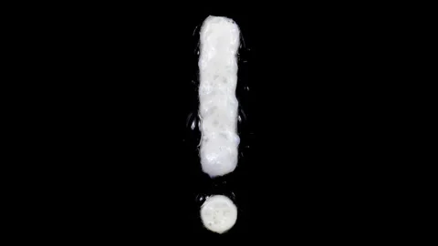 Egg white frying exclamation mark, two looped 10 seconds duration versions Stock Footage 130899352