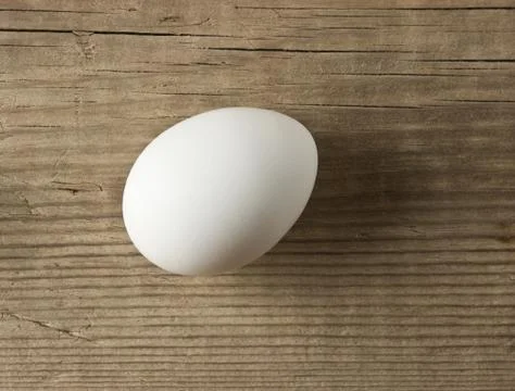 Egg on a wooden background Stock Photos