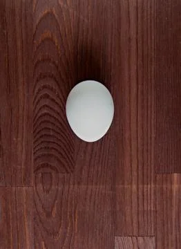 Egg on a wooden surface Stock Photos