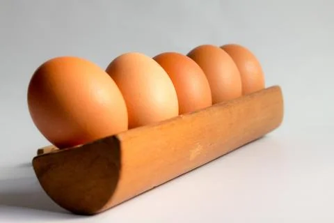 Egg in a wooden tray white background Stock Photos