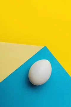 Egg on yellow-blue background Stock Photos