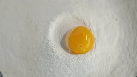 Egg Yolk is Added to Flour Slow-motion Stock Footage 99162732